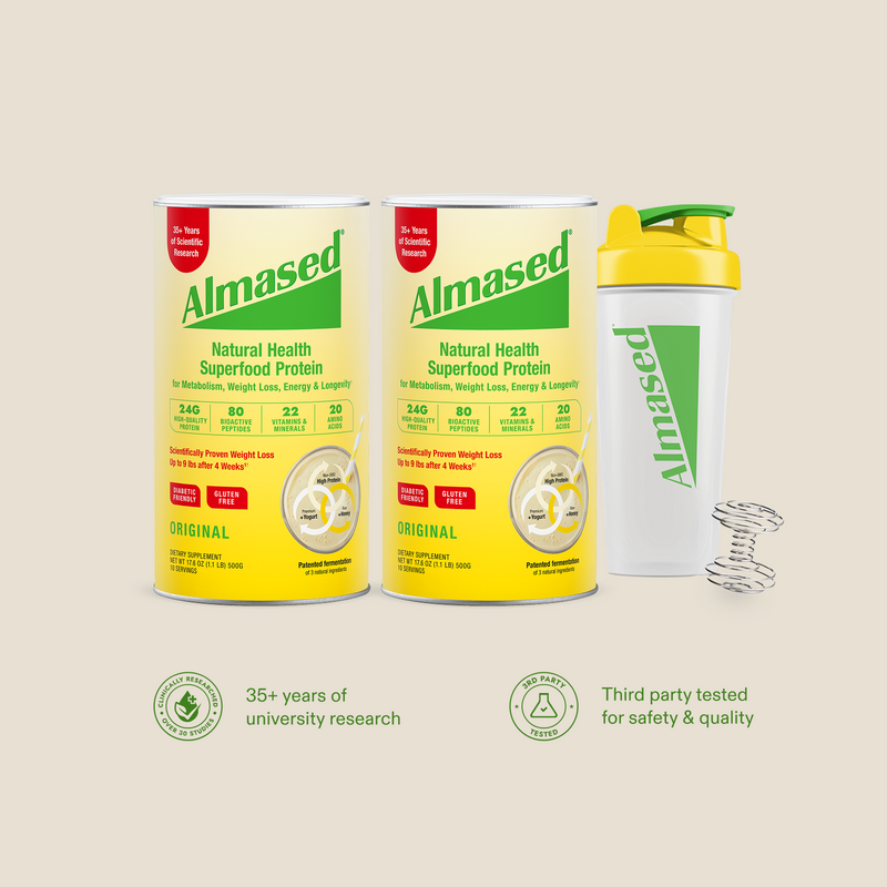 Almased original flavor protein shake containers and shaker bottle on a beige background